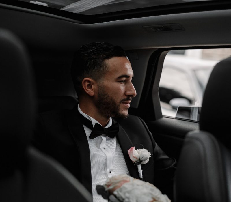 groom-sitting-in-the-back-of-a-car-2022-11-10-07-59-36-utc