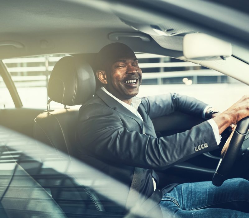 smiling-young-african-businessman-driving-in-the-c-2024-09-15-07-41-03-utc-scaled